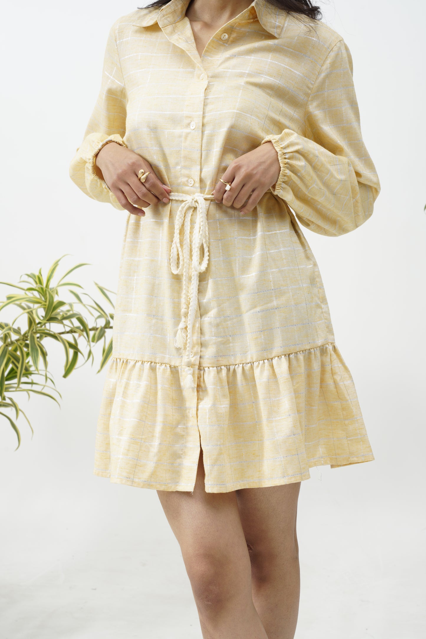 yellow dress with contrast tied belt .long sleeve elasticated sleeves.spread collar .fastens at the front center