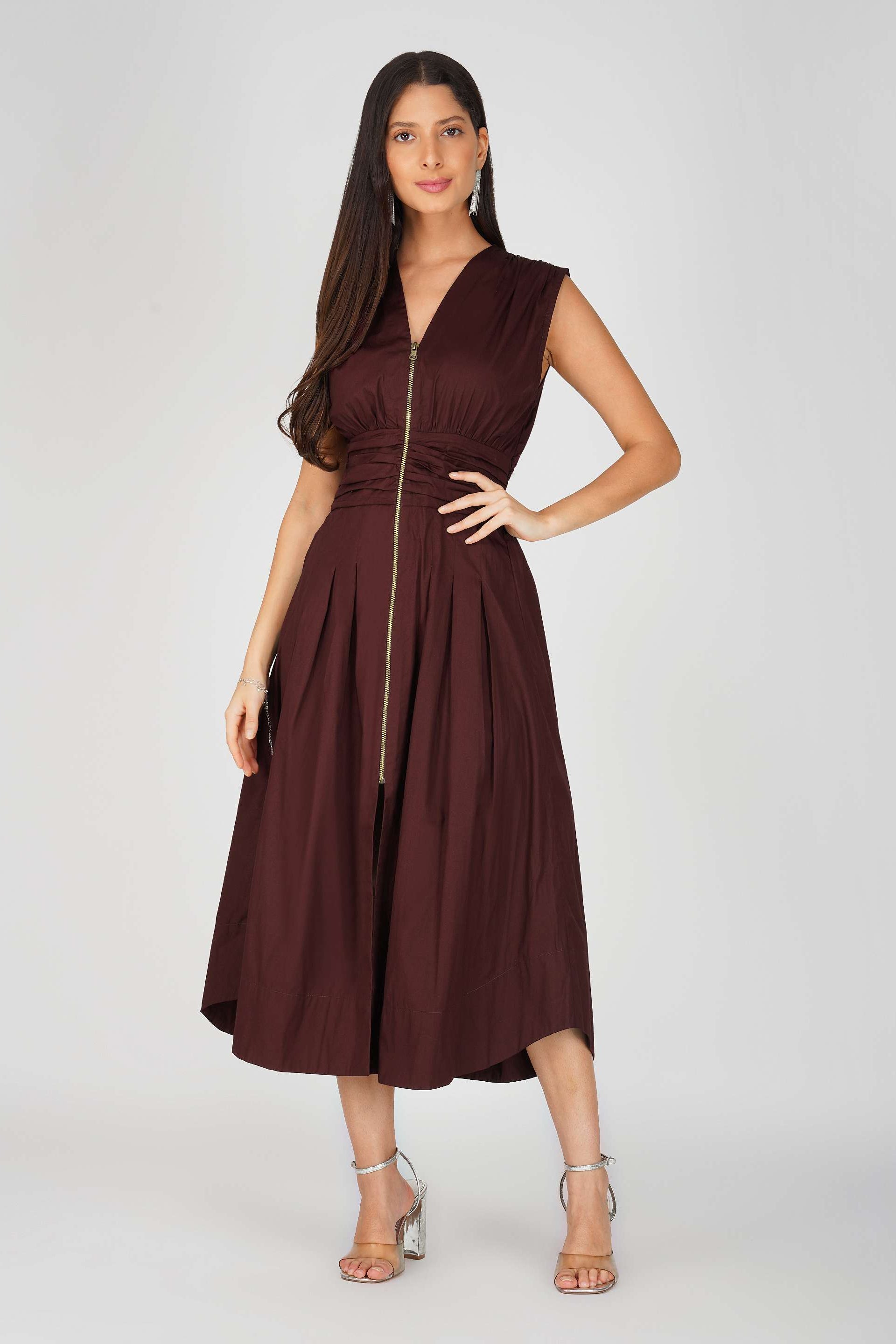 Woman wearing a brown dress with a zipper on a white background