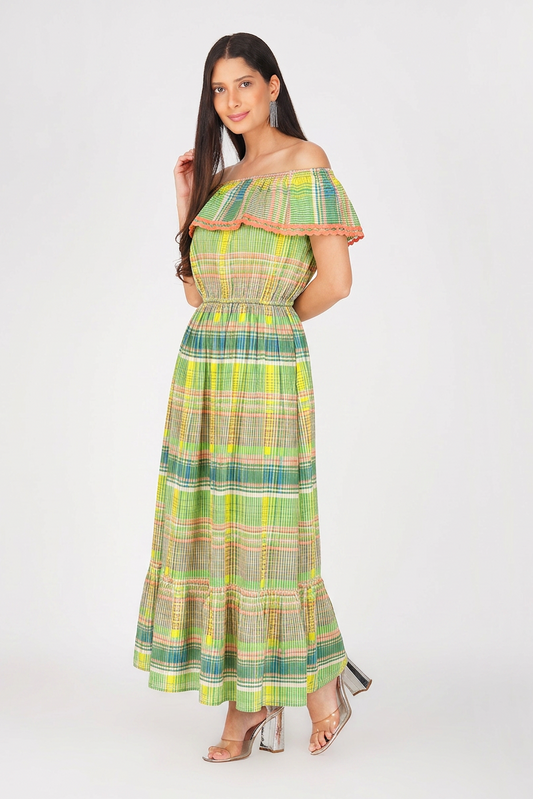 Woman wearing a green plaid dress with ruffled sleeves on a white background