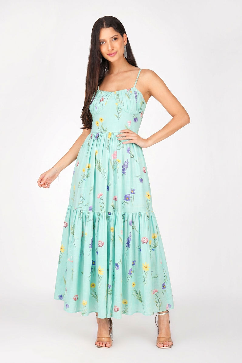 Woman wearing a light blue floral dress on a white background